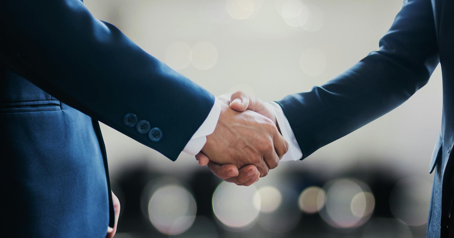 Two people shaking hands in a business setting